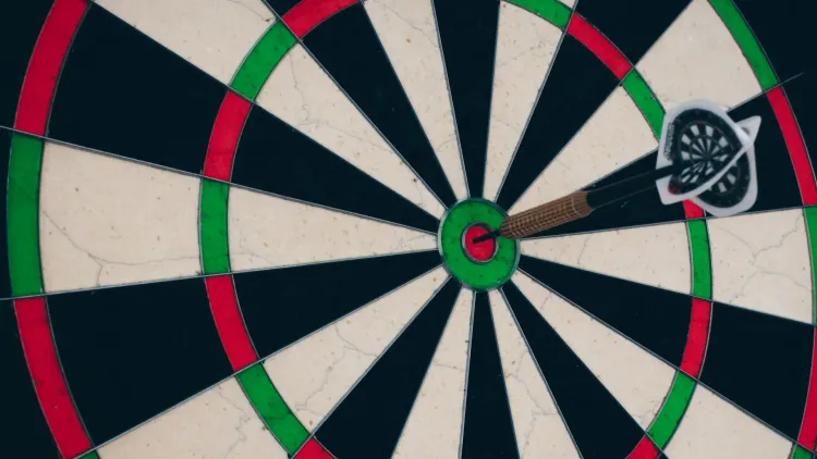 Dartboard with dart sticking in bullseye